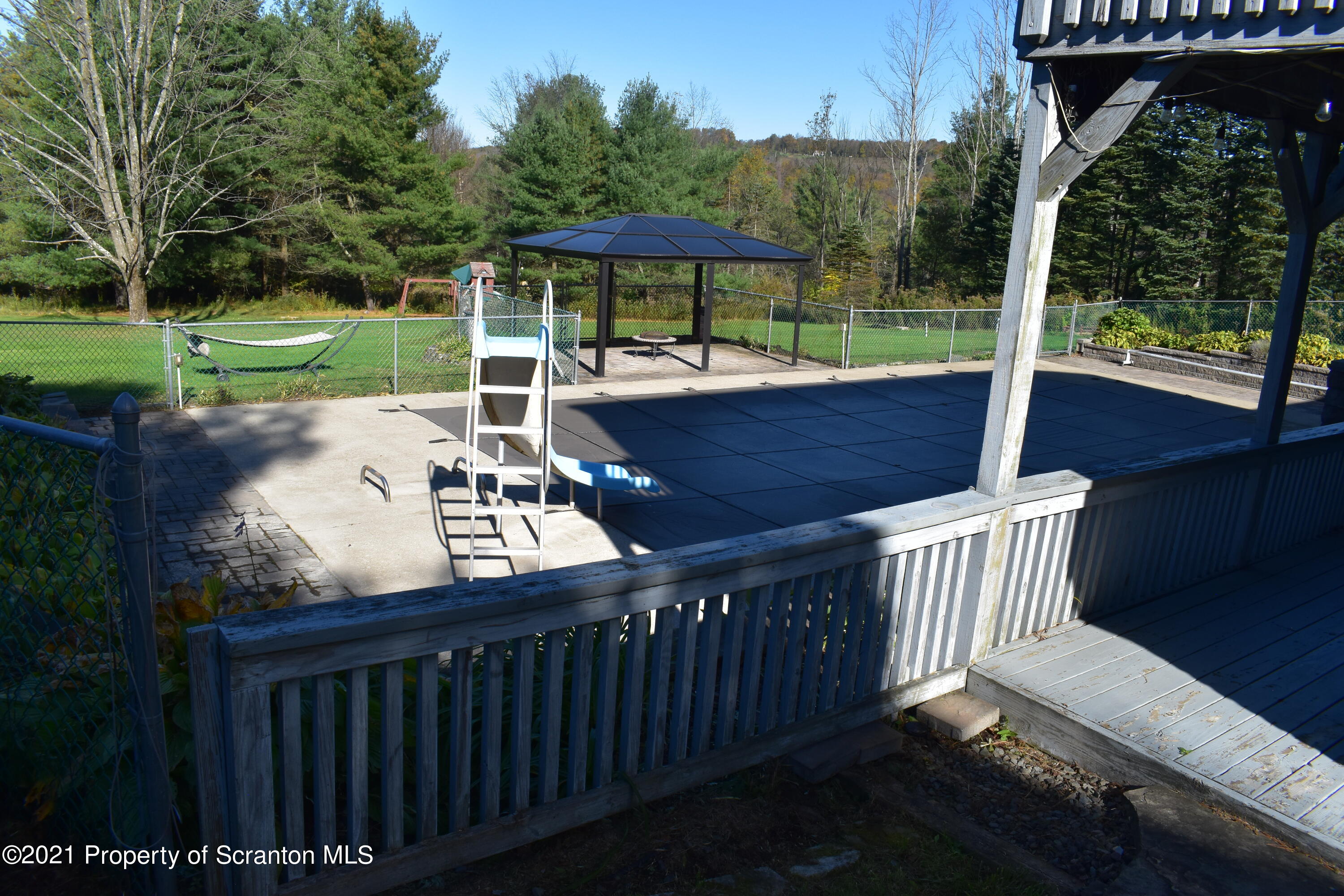 15375 State Rte 3001 Montrose, PA 18801 - Photo 60 of 82 a view of a patio with a table chairs and a fire pit