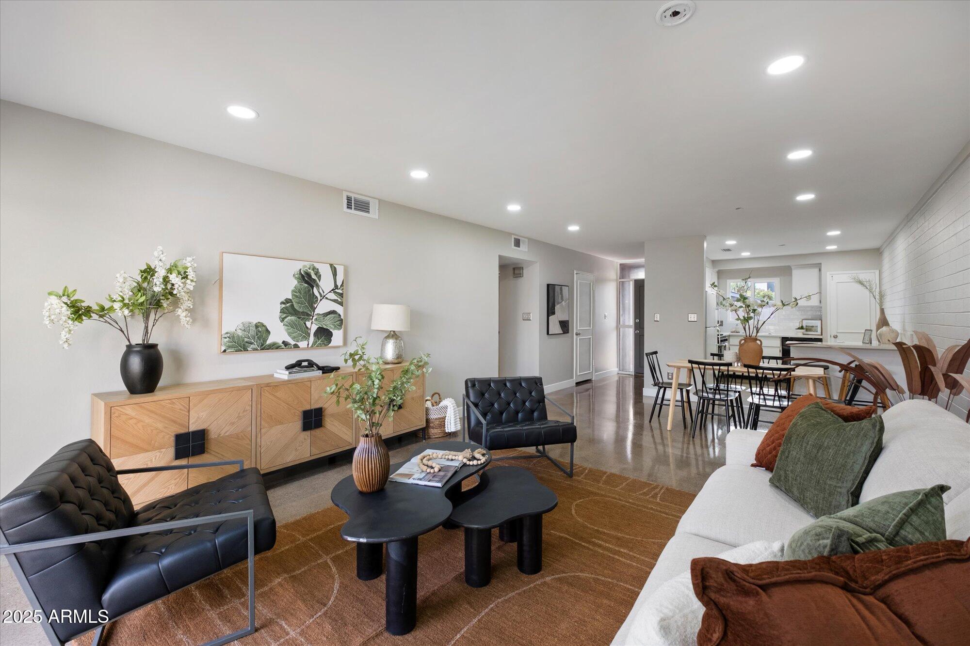 1450 East Bethany Home Road, Unit 8 Phoenix, AZ 85014 - Photo 10 of 29 a living room with furniture kitchen view and a table