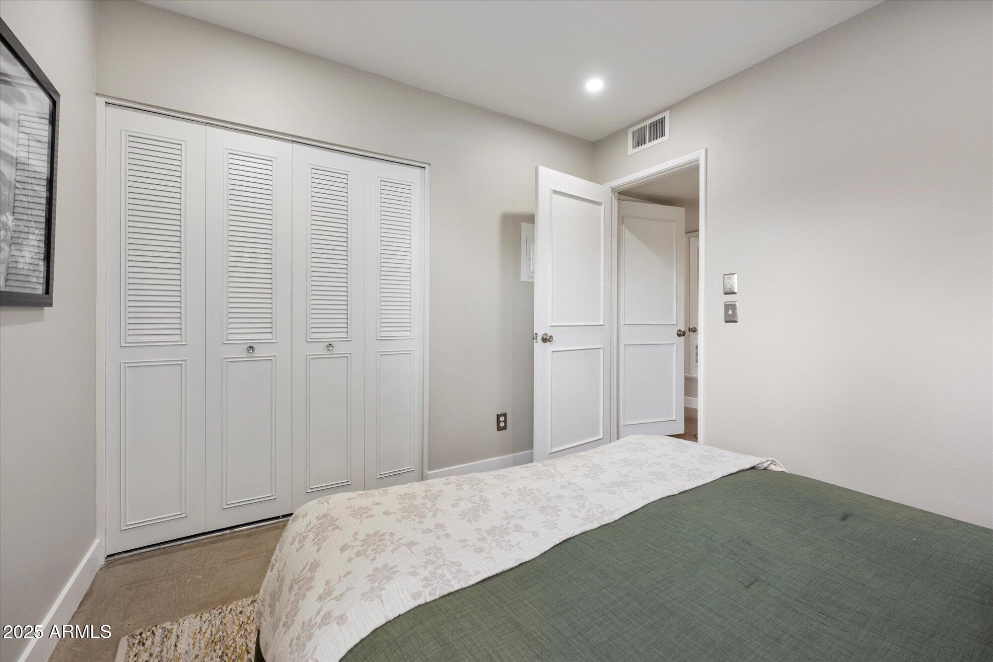 1450 East Bethany Home Road, Unit 8 Phoenix, AZ 85014 - Photo 16 of 29 a bedroom with a bed and a shower