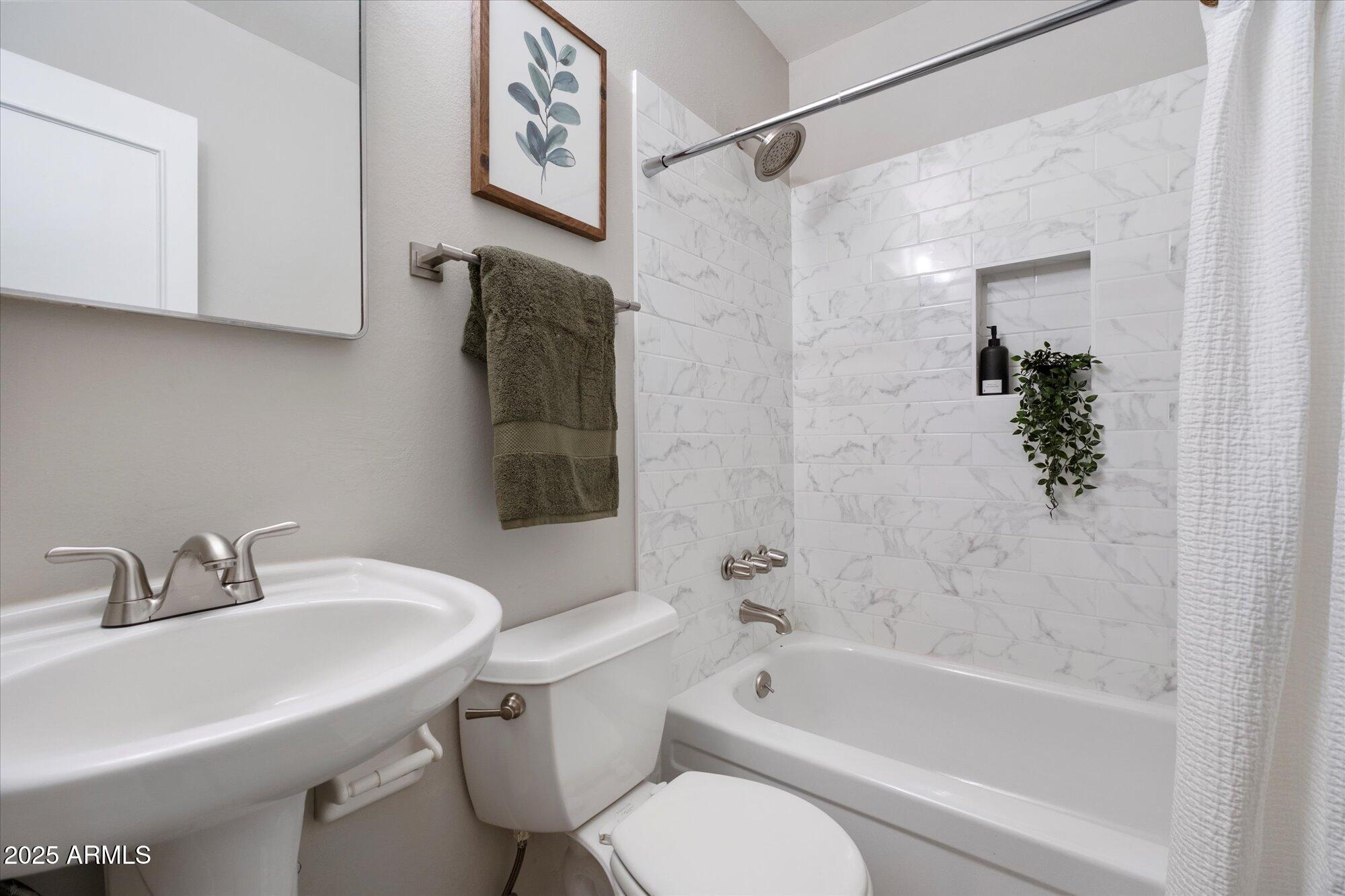 1450 East Bethany Home Road, Unit 8 Phoenix, AZ 85014 - Photo 17 of 29 a bathroom with a sink toilet and shower