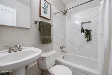 a bedroom with a bed and a shower