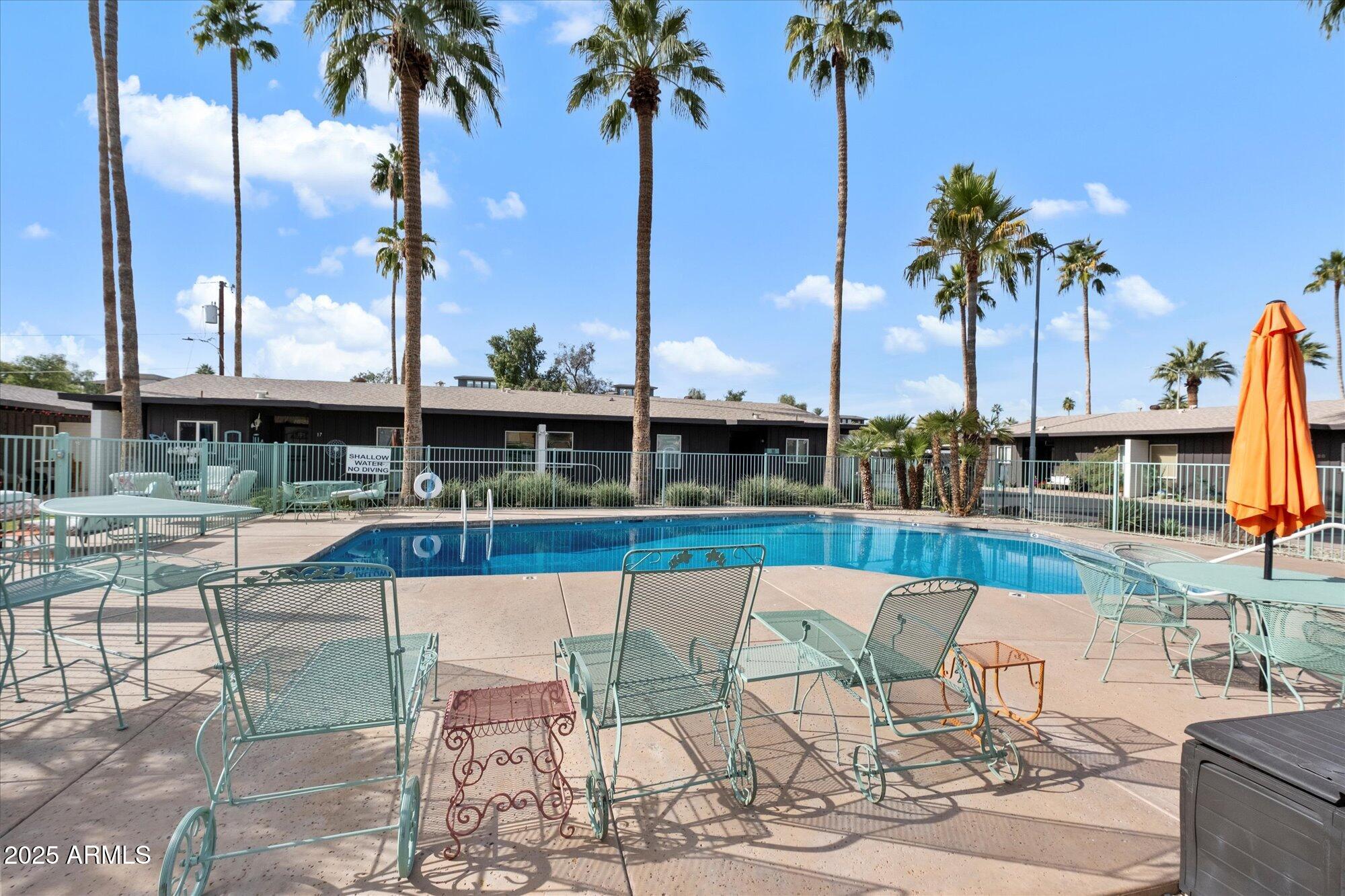 1450 East Bethany Home Road, Unit 8 Phoenix, AZ 85014 - Photo 23 of 29 a view of a swimming pool with a table and chairs