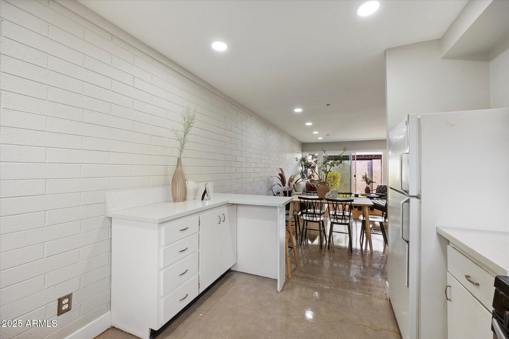 1450 East Bethany Home Road, Unit 8 Phoenix, AZ 85014 - Photo 5 of 29 a kitchen with a table and chairs