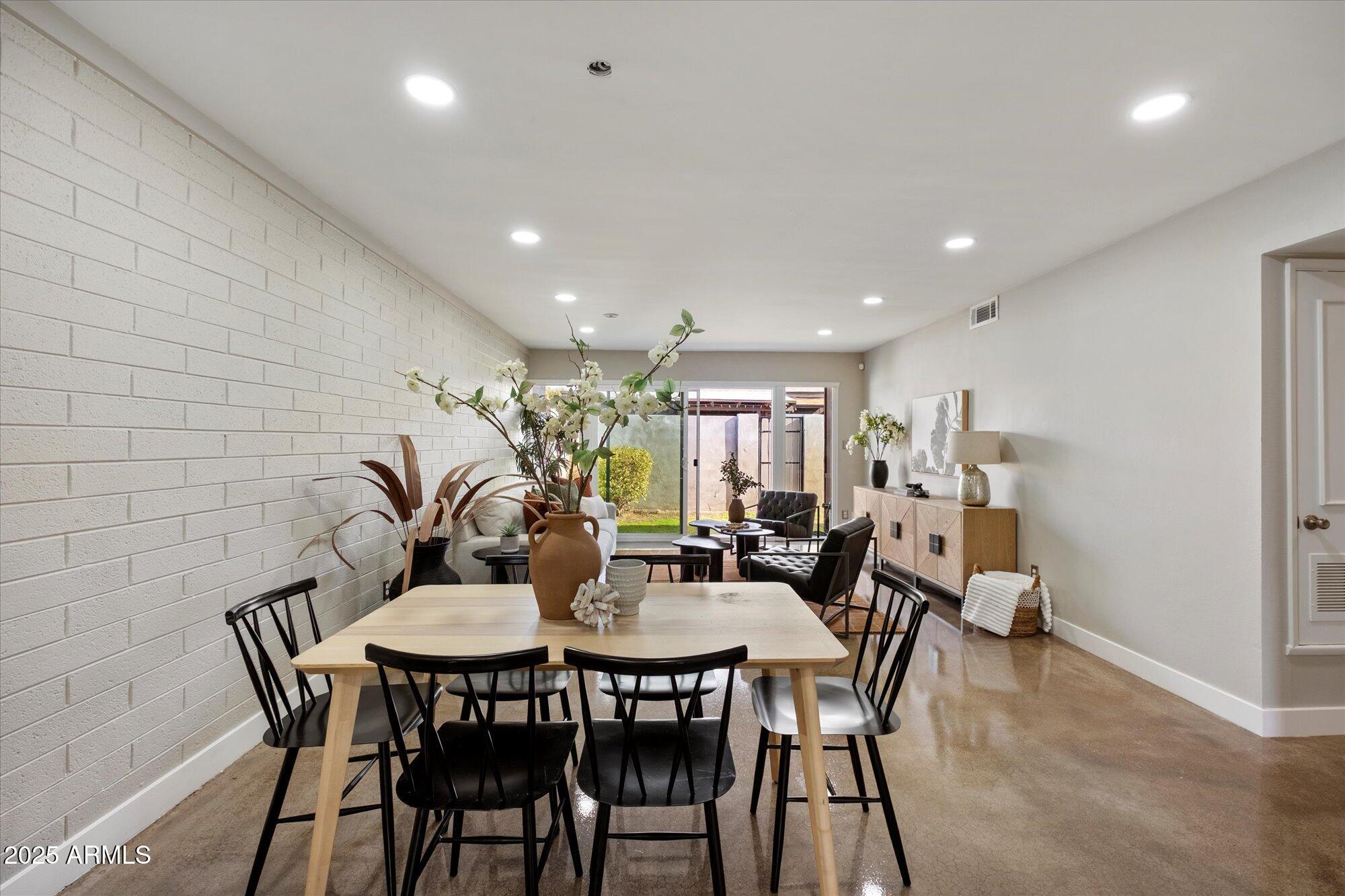 1450 East Bethany Home Road, Unit 8 Phoenix, AZ 85014 - Photo 7 of 29 a view of a dining room with furniture
