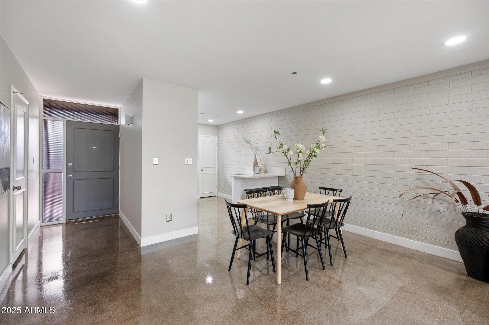 1450 East Bethany Home Road, Unit 8 Phoenix, AZ 85014 - Photo 8 of 29 a view of a dining room with furniture and chandelier
