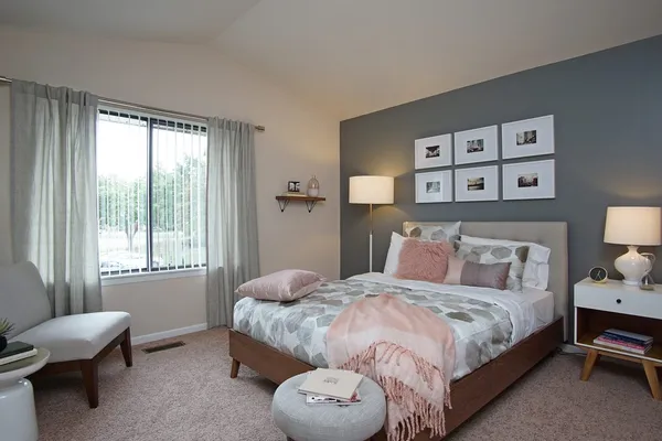 a bedroom with a bed and a window