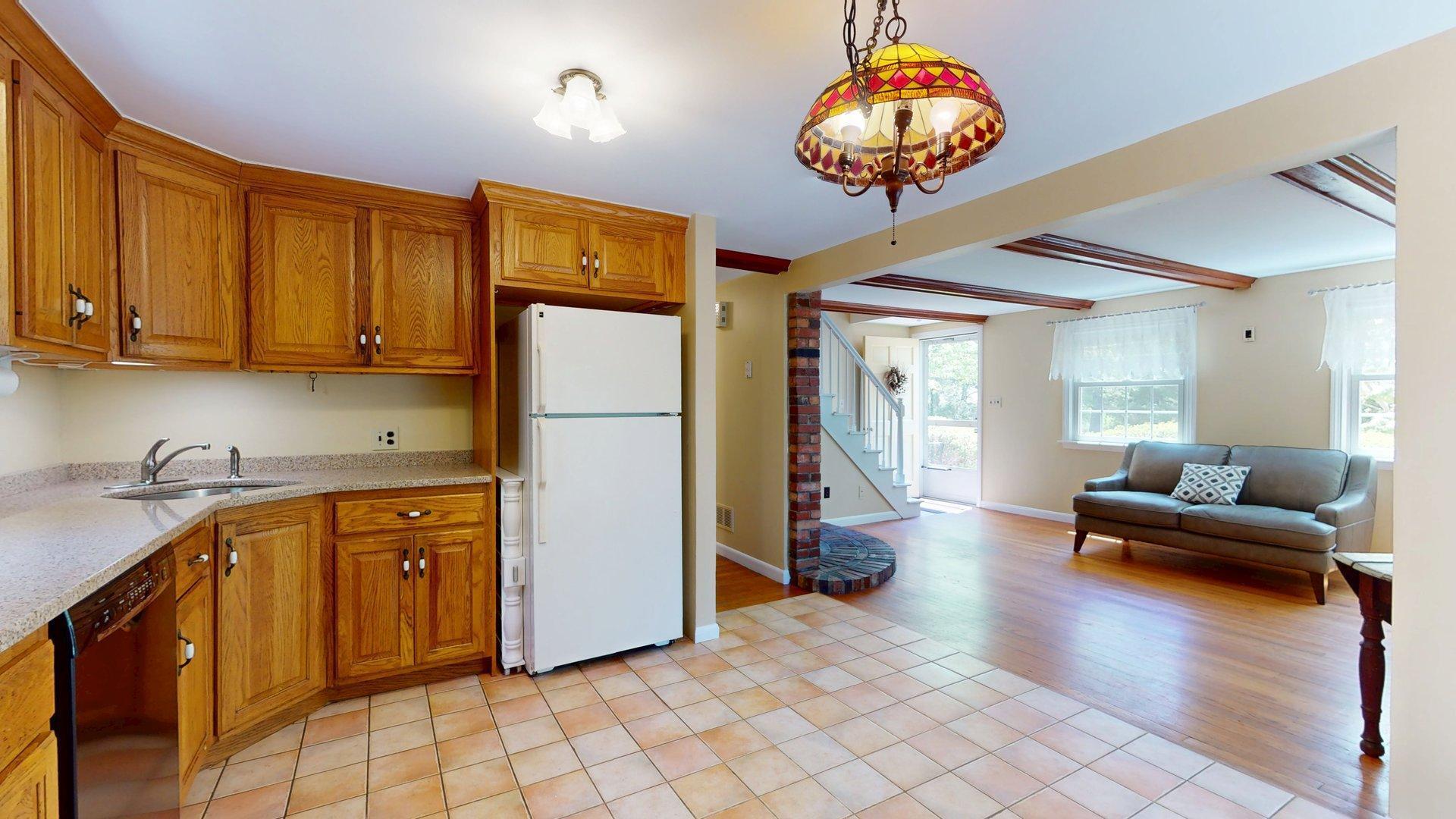 26 Newport Road Brewster, MA 02631 - Photo 15 of 61 a kitchen with stainless steel appliances granite countertop a refrigerator a stove a sink dishwasher and a dining table with the view of kitchen