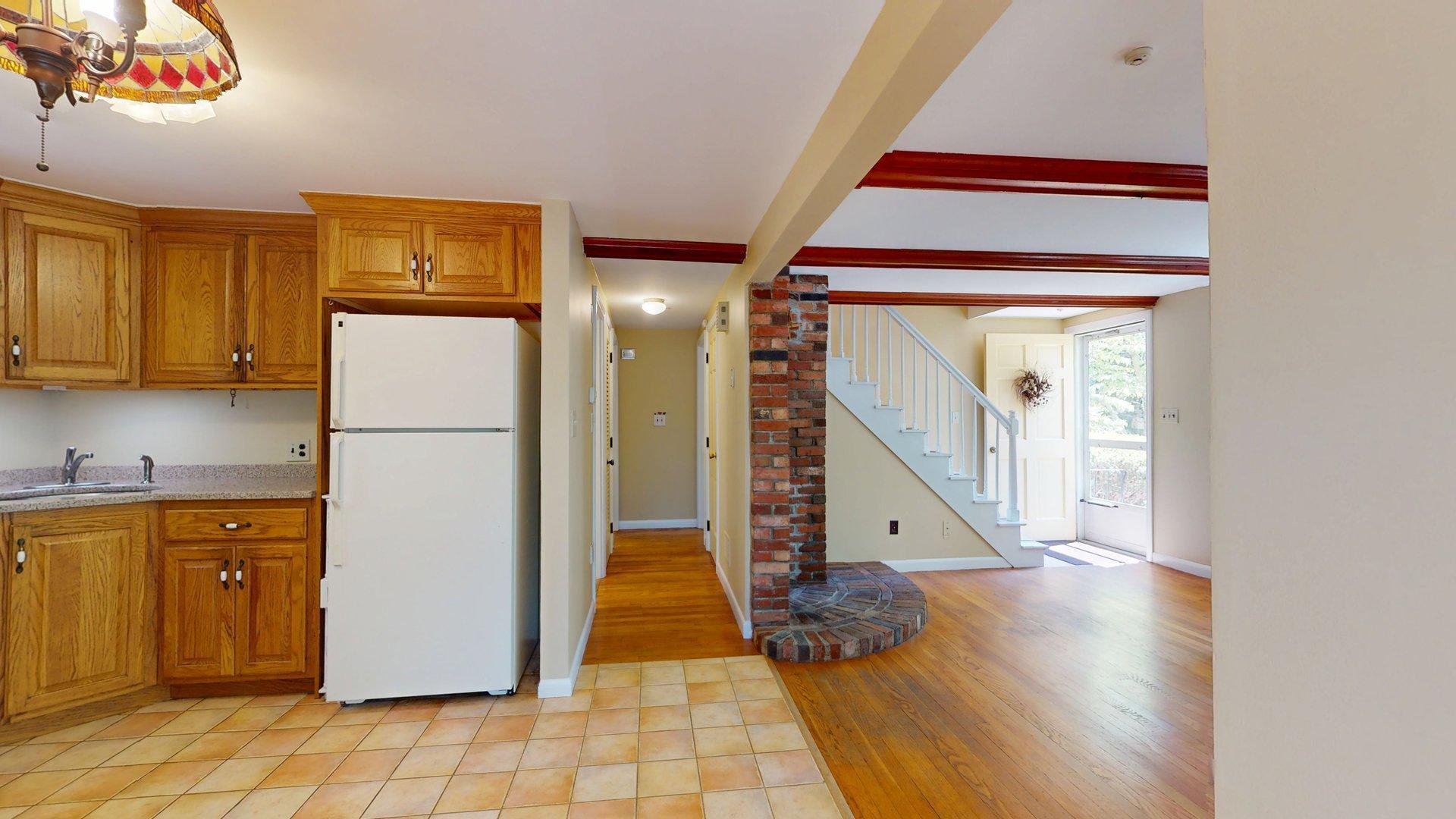 26 Newport Road Brewster, MA 02631 - Photo 17 of 61 a room with a open kitchen view and a wooden floor