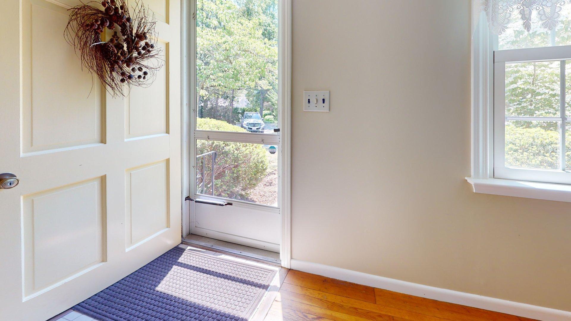 26 Newport Road Brewster, MA 02631 - Photo 3 of 61 a view of a hallway with wooden floor and a window