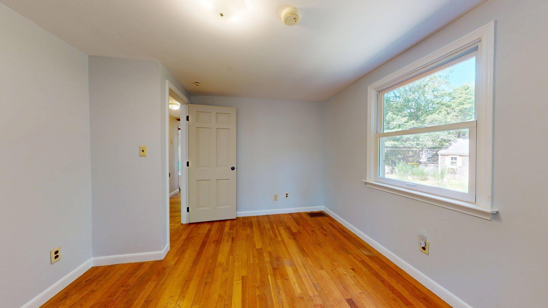 26 Newport Road Brewster, MA 02631 - Photo 57 of 61 a view of empty room with wooden floor and fan