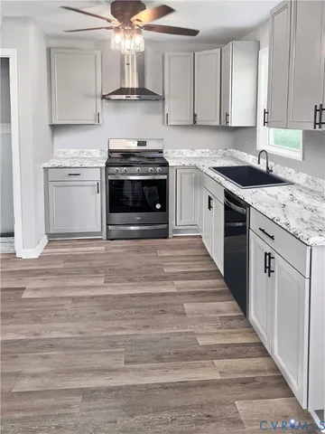a kitchen with stainless steel appliances granite countertop a stove and a sink