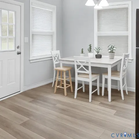 a dining room with wooden floor and breakfast area