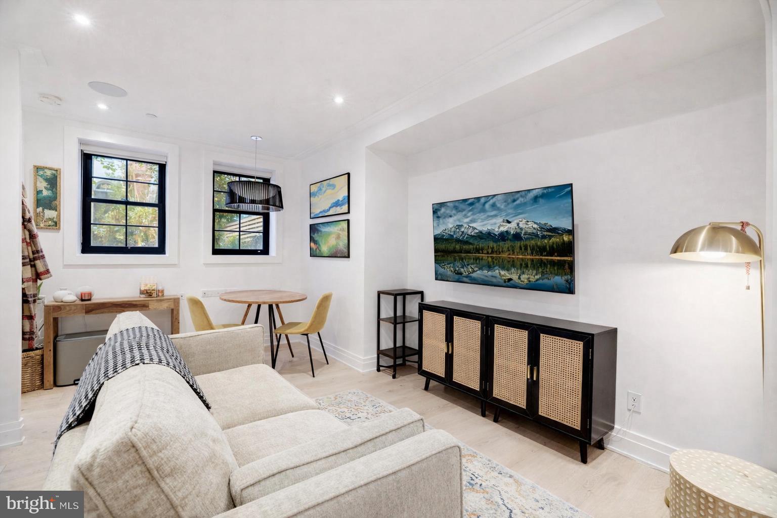 1204 Q Street Northwest, Unit 1 Washington, DC 20009 - Photo 2 of 12 a living room with furniture tv and a window
