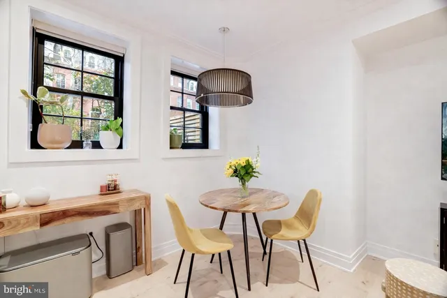 a view of a dining room with furniture and window
