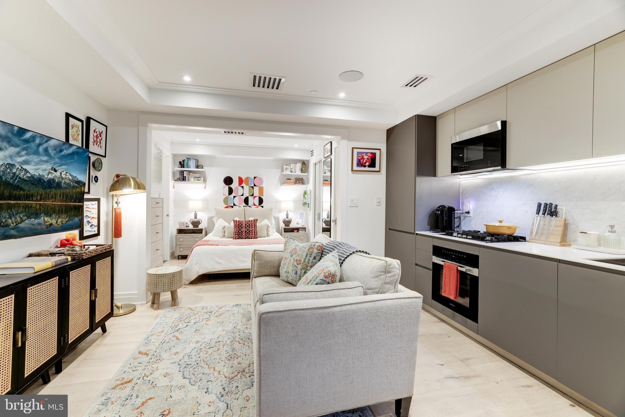 1204 Q Street Northwest, Unit 1 Washington, DC 20009 - Photo 5 of 12 a living room with furniture and a flat screen tv