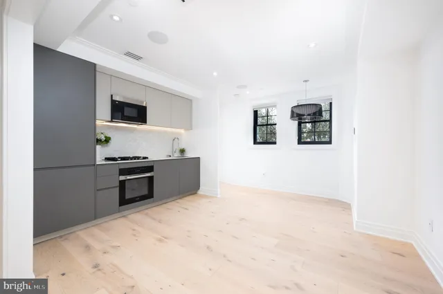 a kitchen with stainless steel appliances a refrigerator and a stove top oven
