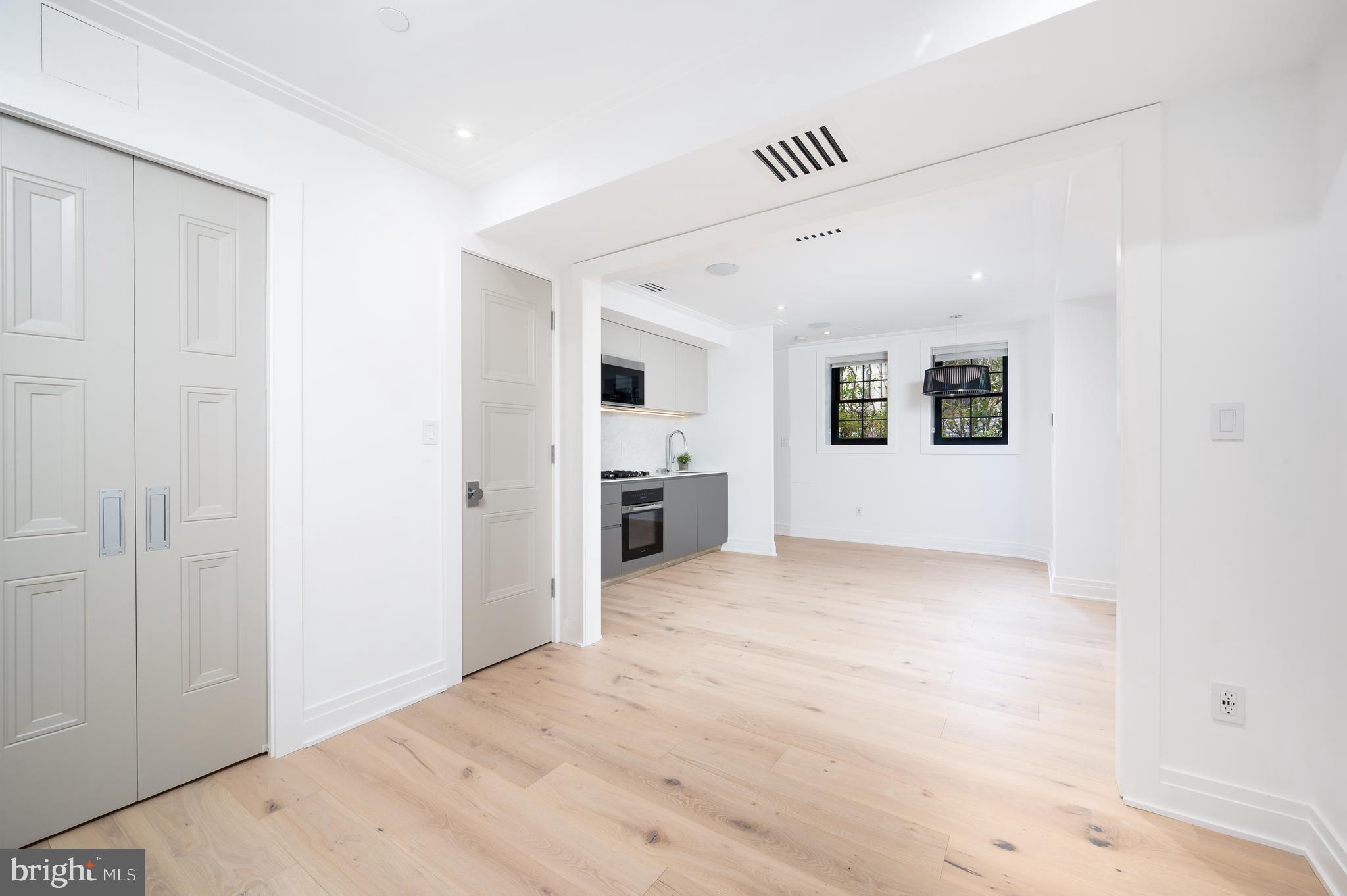 1204 Q Street Northwest, Unit 1 Washington, DC 20009 - Photo 10 of 12 a view of a big room with wooden cabinet and windows