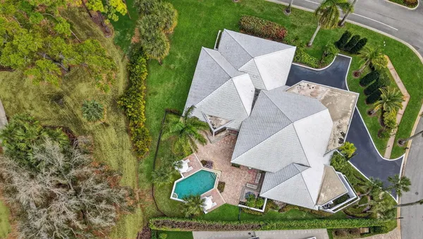 an aerial view of a house with outdoor space and a fountain