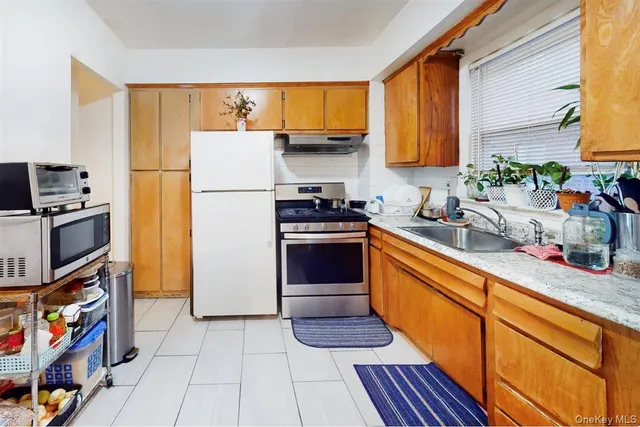 a kitchen with stainless steel appliances a stove a sink and a refrigerator