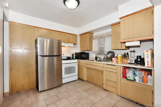 a kitchen with stainless steel appliances granite countertop a refrigerator sink and cabinets
