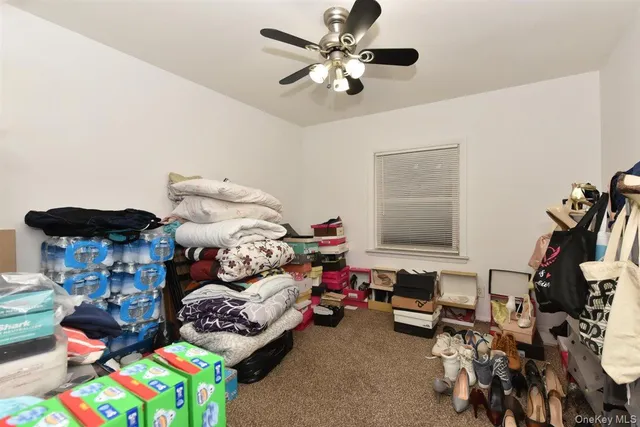 a bedroom with furniture and a fan