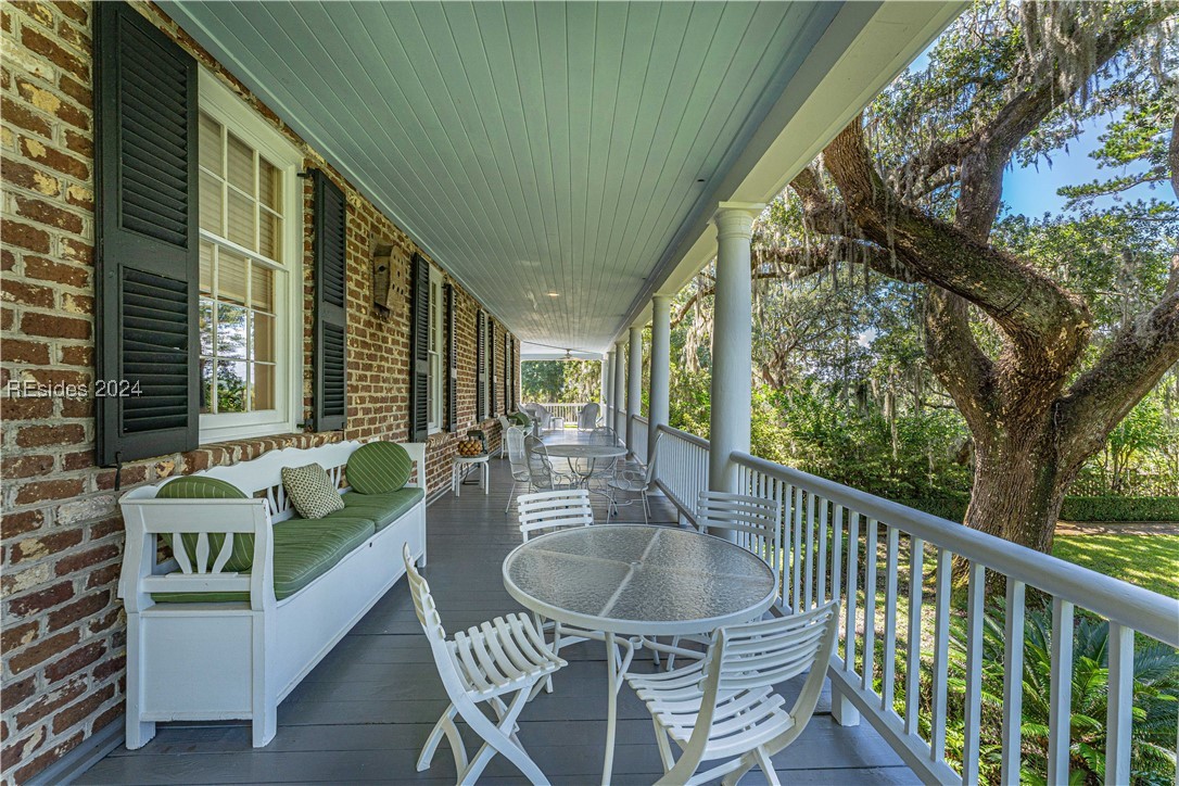 92 Dean Hall Road Seabrook, SC 29940 - Photo 48 of 99 Primary residence 2nd floor porch; one of four sides to the piazza; shaded breezes from all four compass points