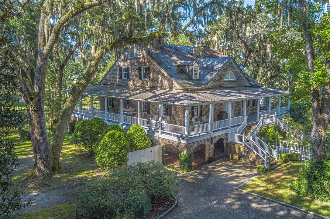 92 Dean Hall Road Seabrook, SC 29940 - Photo 5 of 99 North elevation; the primary residence is fully canopied under LIve Oaks