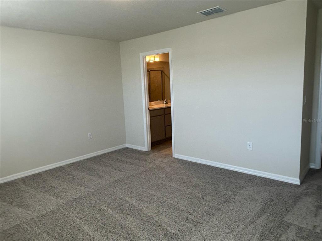 16274 Bright Leaf Road Winter Garden, FL 34787 - Photo 18 of 38 a view of an empty room with closet and wooden floor