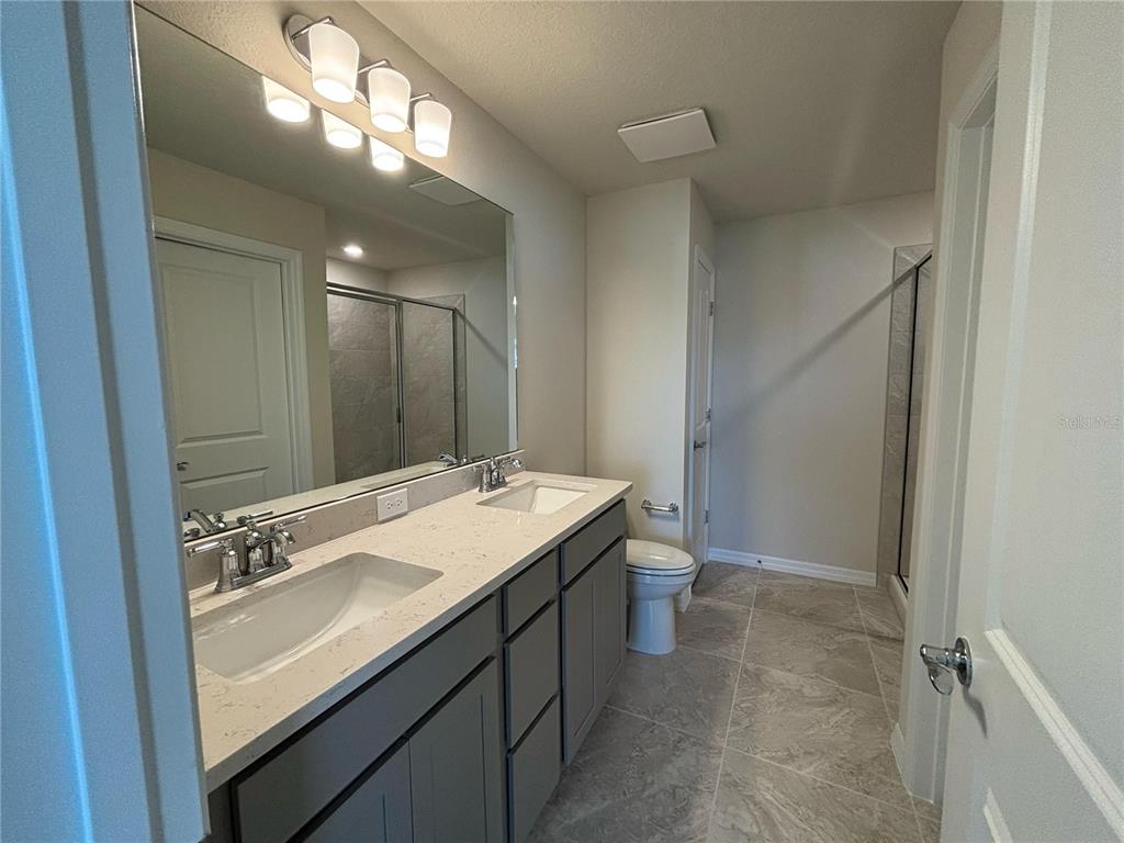 16274 Bright Leaf Road Winter Garden, FL 34787 - Photo 21 of 38 a bathroom with a sink a vanity and a mirror