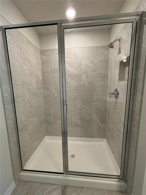 16274 Bright Leaf Road Winter Garden, FL 34787 - Photo 22 of 38 a bathroom with a shower