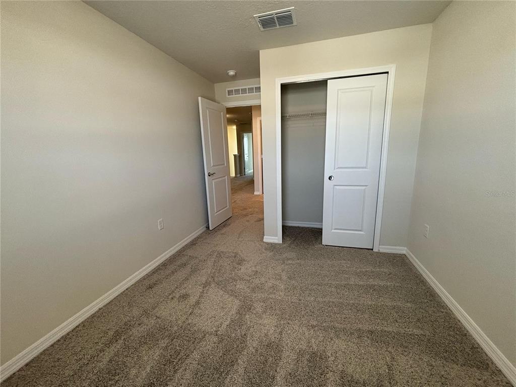 16274 Bright Leaf Road Winter Garden, FL 34787 - Photo 25 of 38 an empty room with closet and mirror