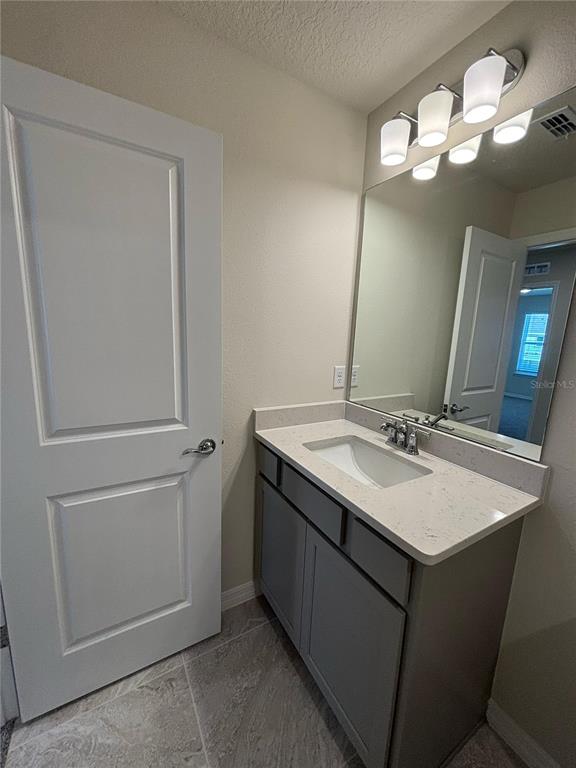 16274 Bright Leaf Road Winter Garden, FL 34787 - Photo 28 of 38 a bathroom with a sink and a mirror