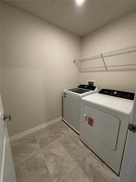 16274 Bright Leaf Road Winter Garden, FL 34787 - Photo 31 of 38 a utility room with dryer and washer