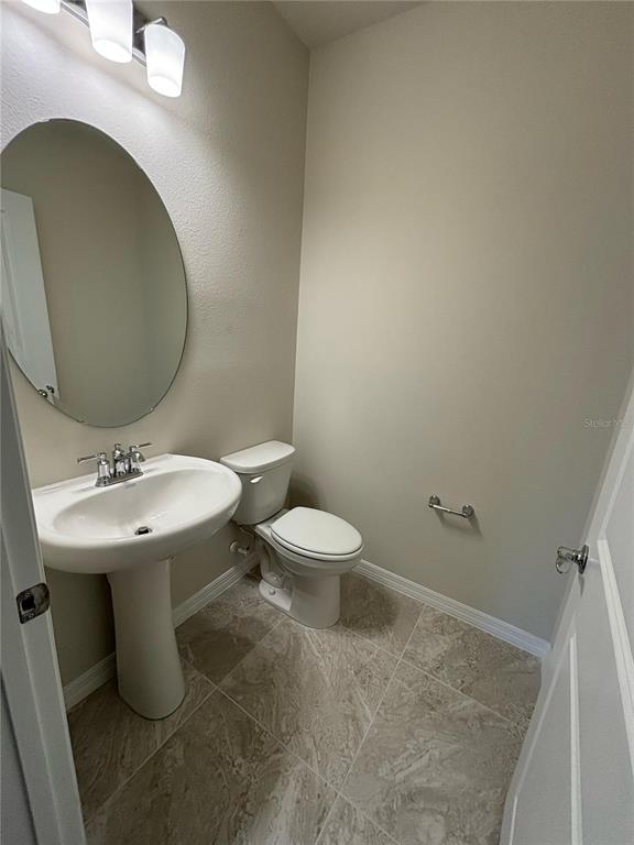 16274 Bright Leaf Road Winter Garden, FL 34787 - Photo 9 of 38 a bathroom with a sink toilet and a mirror