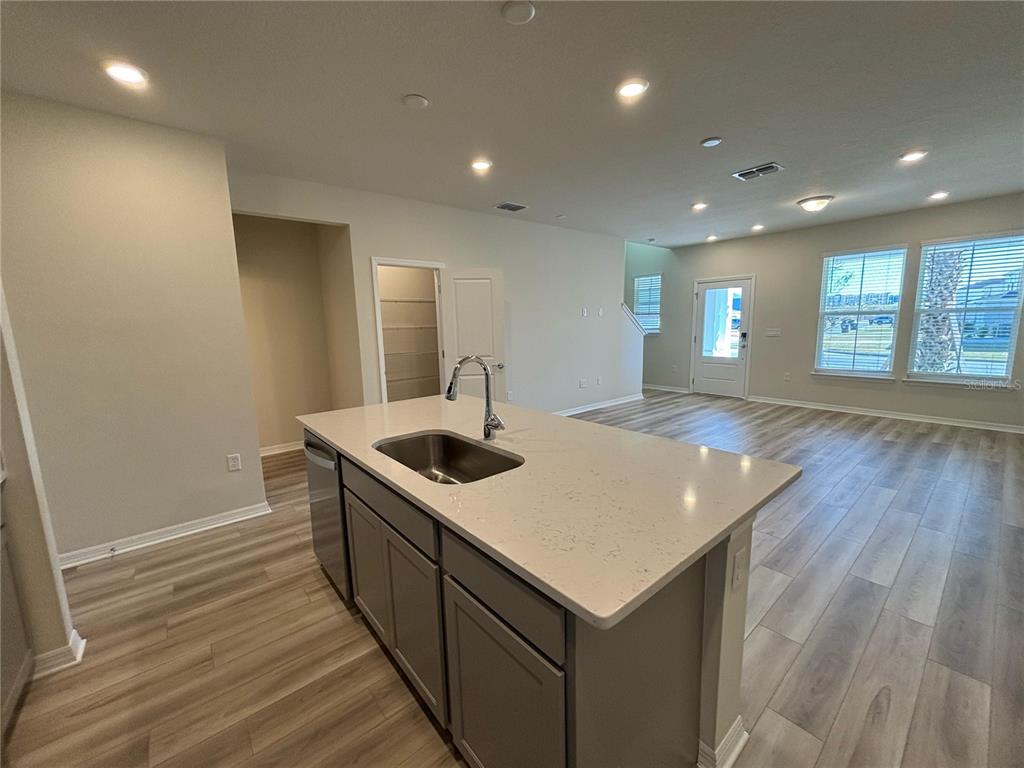 16274 Bright Leaf Road Winter Garden, FL 34787 - Photo 10 of 38 a kitchen with a stove and wooden floor