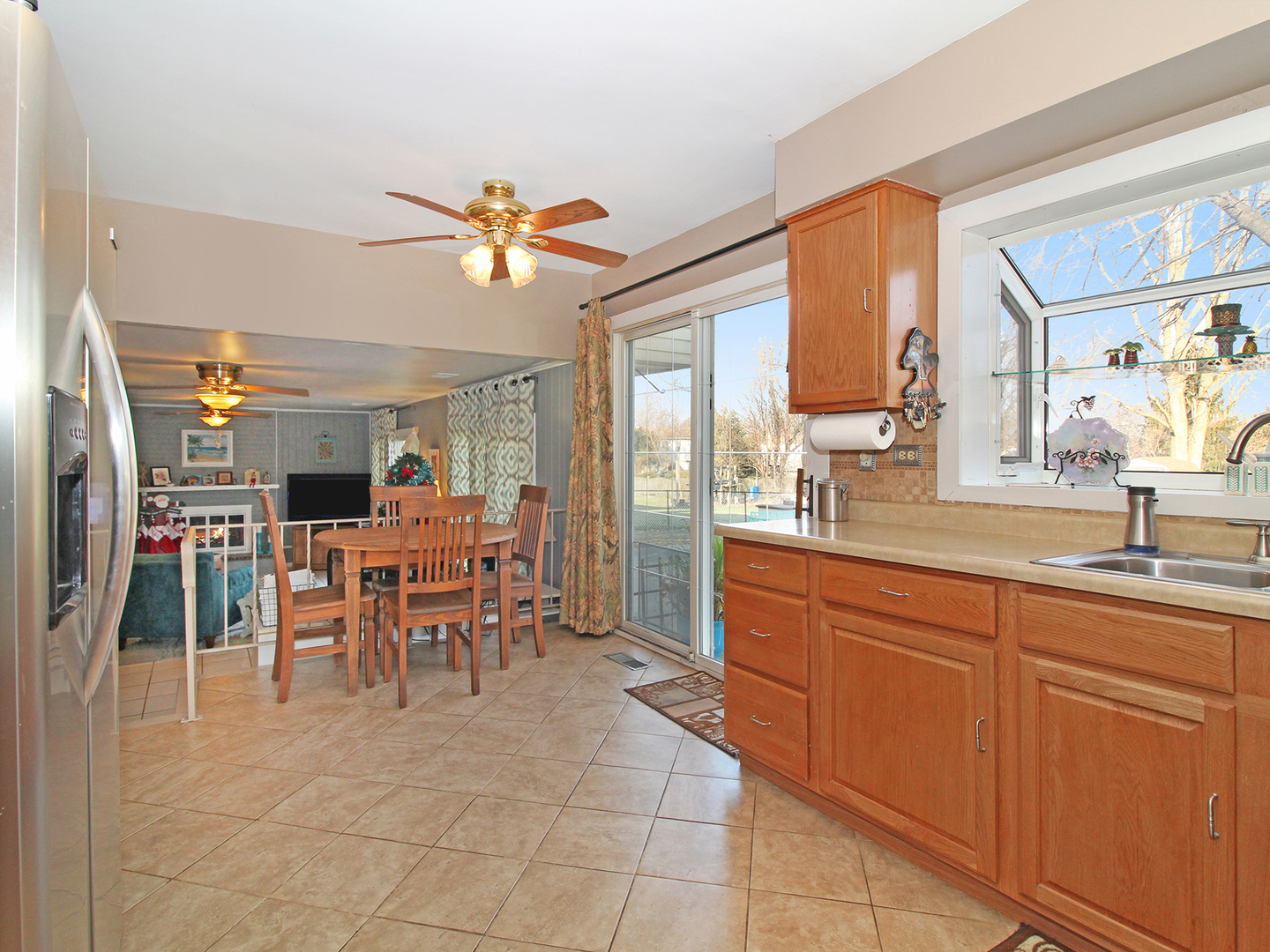 554 Rockhurst Road Bolingbrook, IL 60440 - Photo 10 of 29 a large kitchen with kitchen island granite countertop a counter space dining table and stainless steel appliances