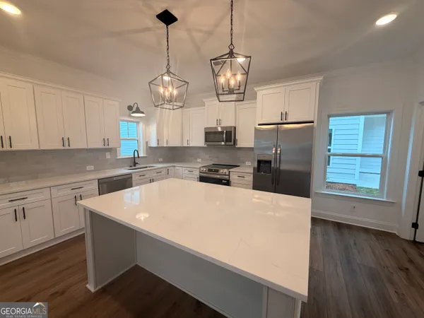 a kitchen with refrigerator cabinets and wooden floor