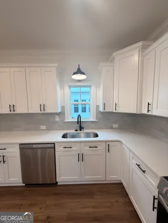 a kitchen with a sink cabinets and window