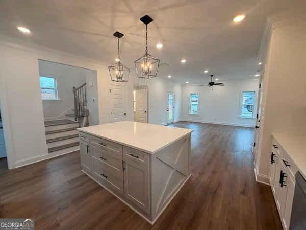 a kitchen with a wooden floor and white appliances