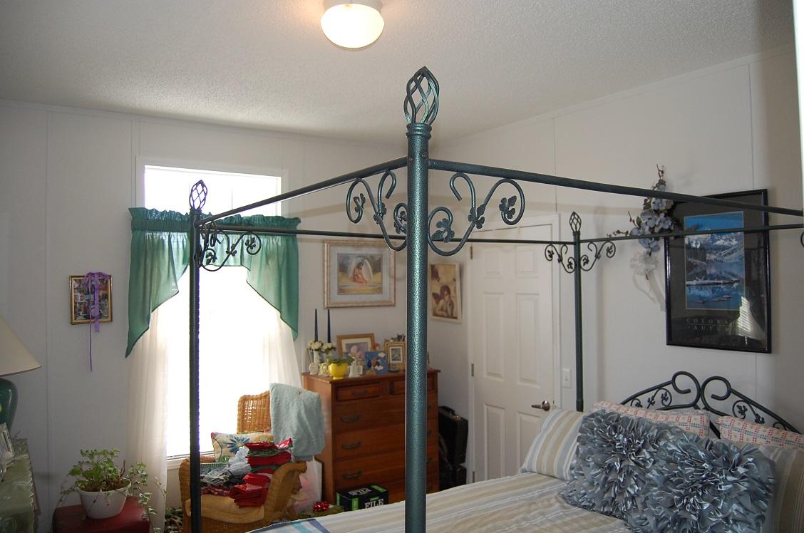 278 Dusty Rock Road Northwest Riner, VA 24149 - Photo 12 of 21 a bedroom with a bed window and a chandelier