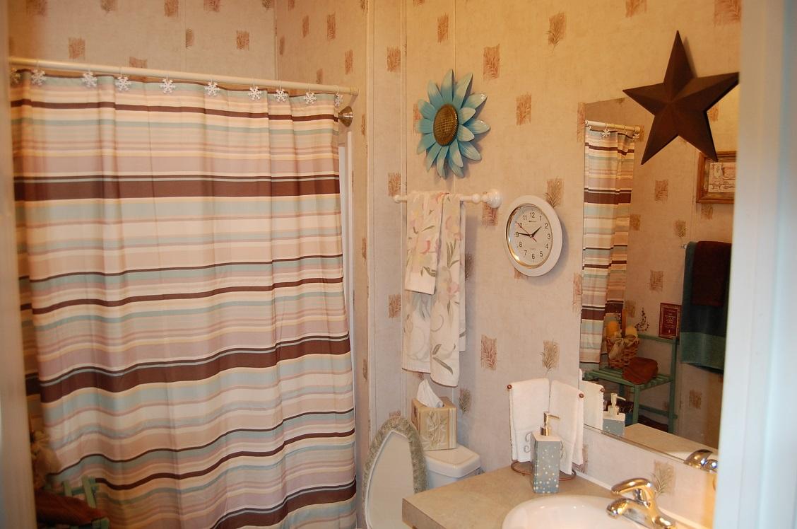 278 Dusty Rock Road Northwest Riner, VA 24149 - Photo 13 of 21 a bathroom with a shower curtain and a sink