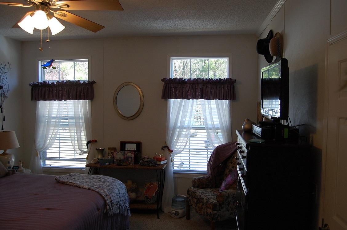 278 Dusty Rock Road Northwest Riner, VA 24149 - Photo 9 of 21 a bed room with a bed mirror and window