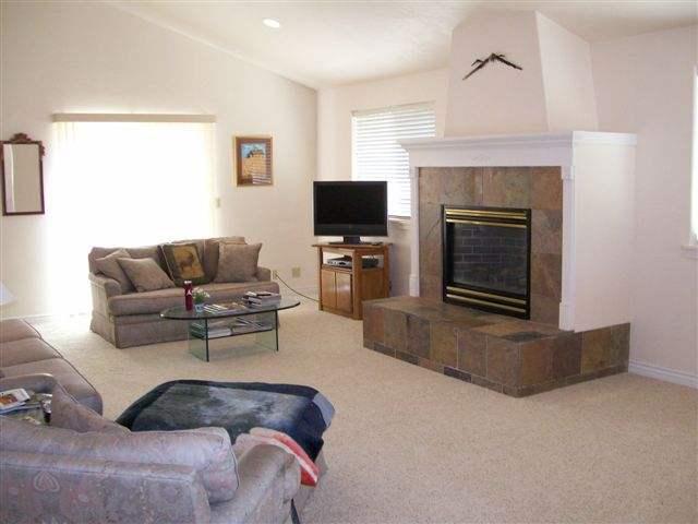 540 Birch Court Rifle, CO 81650 - Photo 2 of 5 a living room with furniture a flat screen tv and a fireplace