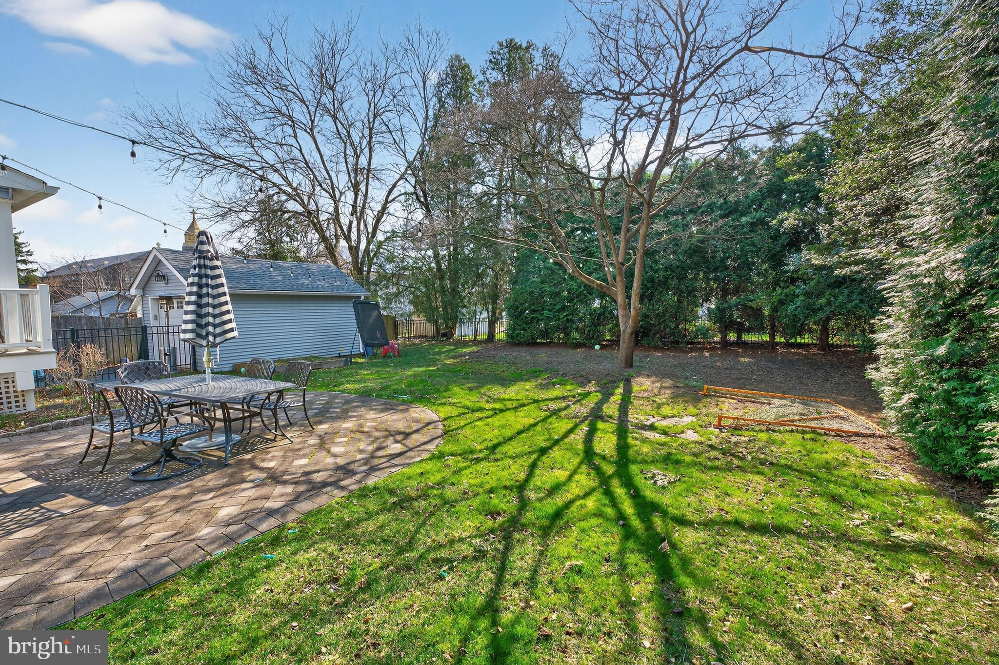 148 Windsor Avenue Haddonfield, NJ 08033 - Photo 29 of 30 Sunny backyard oasis with lush greenery.