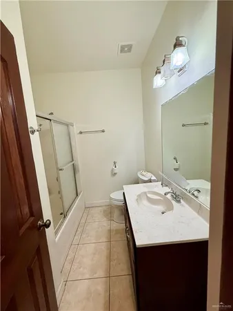 a bathroom with a sink a toilet a mirror and vanity