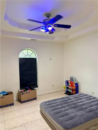 a bedroom with a bed and a chandelier