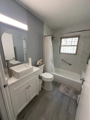 a bathroom with a sink toilet and shower