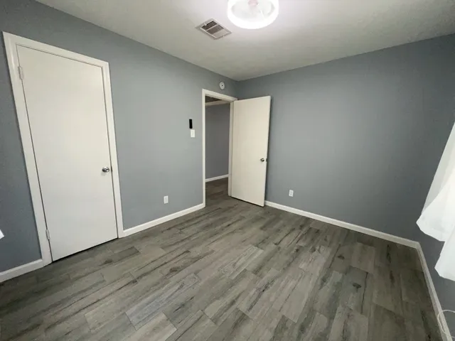 an empty room with wooden floor