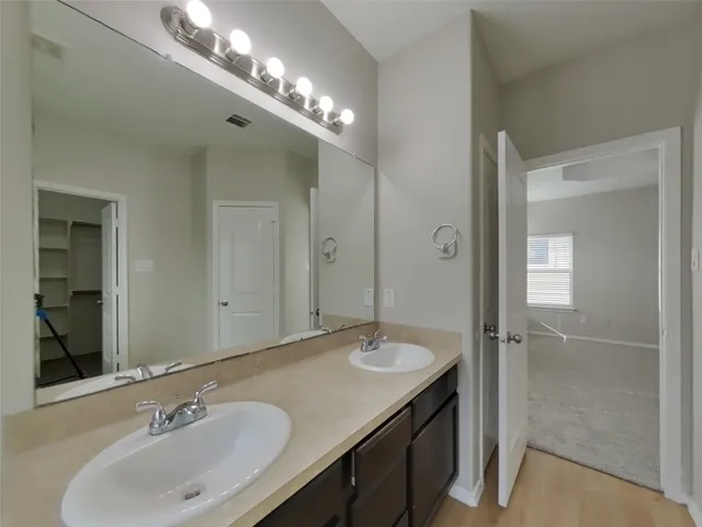 a bathroom with a sink double vanity and a mirror