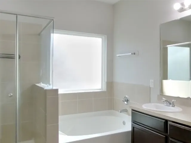 a bathroom with a bathtub and a sink